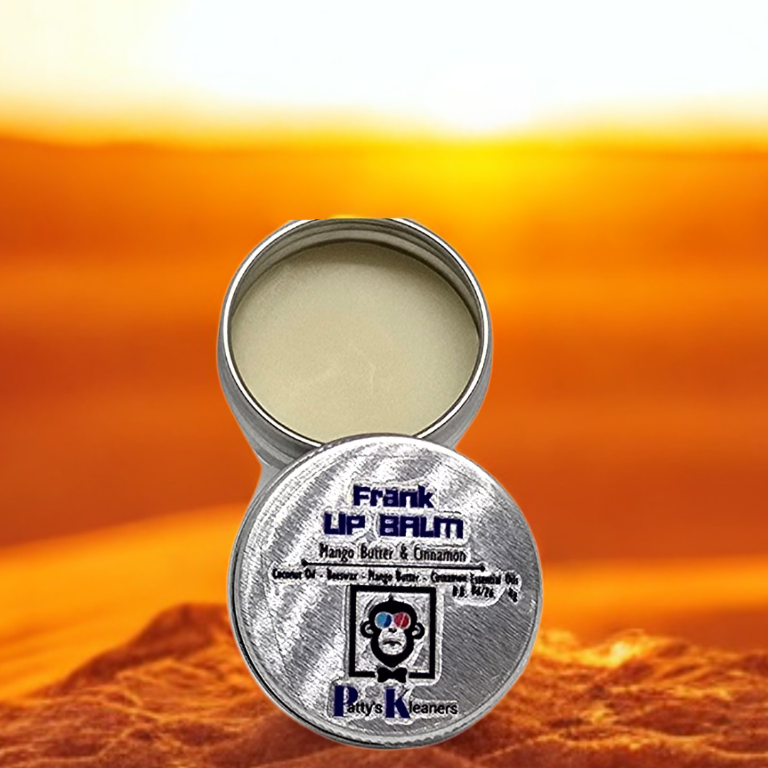 Open tin of Frank Lip Balm with a desert sunset background. 4g.