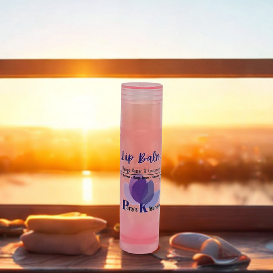 Pattys kleaners in a pink tube. Mango Butter and Cinnamon sitting in a window with a sunset behind