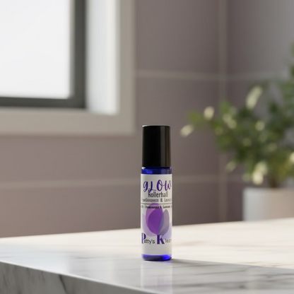 Blue rollerball bottle labelled 'GLOW' on a marble surface with a blurred background